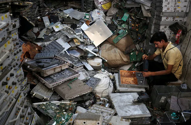 A worker dismantles electronic waste at a workshop in New Delhi, India, June 5, 2018. (Photo by Amit Dave/Reuters)