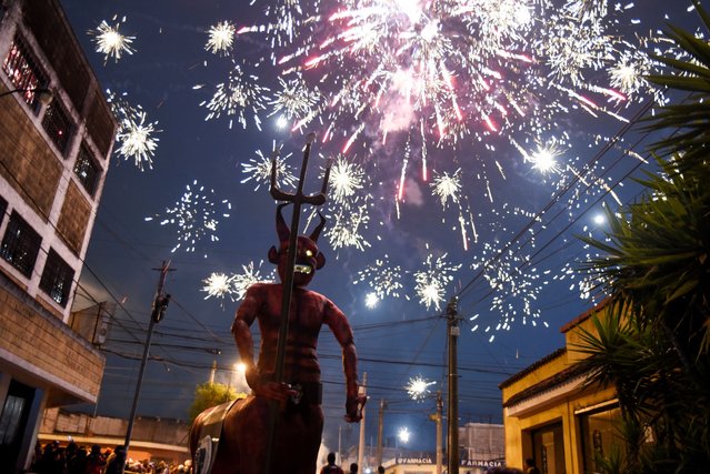 A giant devil figure is displayed during the annual celebration of the “Burning of the Devil”, a festivity associated with the Feast of the Immaculate Conception that honours the city's patron saint and marks the start of the Christmas season, at Colonia Arrivillaga in Guatemala City, Guatemala on December 7, 2024. (Photo by Cristina Chiquin/Reuters)