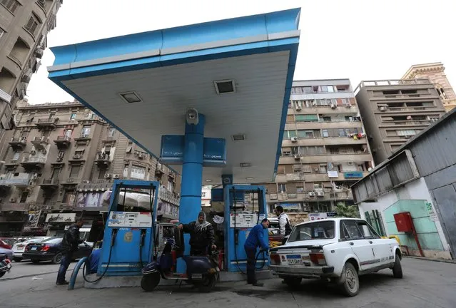 People are seen at a petrol station in Cairo, January 13, 2015. (Photo by Mohamed Abd El Ghany/Reuters)