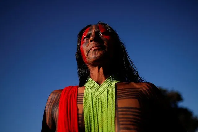 An indigenous person from the Kayapo tribe looks on during the Terra Livre (Free Land) camp, a protest-camp to defend indigenous land and cultural rights that they say are threatened by the right-wing government of Brazil's President Jair Bolsonaro, in Brasilia, Brazil on April 4, 2022. (Photo by Adriano Machado/Reuters)