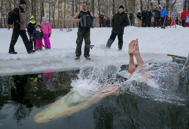 A man plunges into the icy water in St. Petersburg, Russia, Sunday January 25, 2015, marking the 71st anniversary of the breaking the Nazi siege of Leningrad during WWII. (Photo by Dmitry Lovetsky/AP Photo)