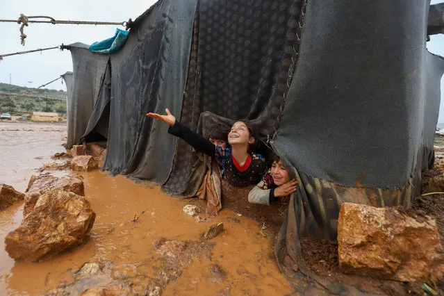 Children play play in the Umm Jurn camp for the displaced, near the village of Kafr Uruq, in Syria's northern rebel-held Idlib province, on January 17, 2021. (Photo by Abdulaziz Ketaz/AFP Photo)
