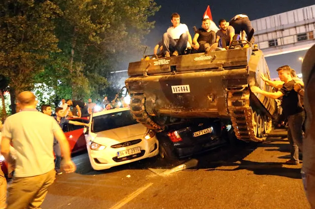 People on a tank run over cars on a road in Istanbul, Turkey, 16 July 2016. Turkish Prime Minister Yildirim reportedly said that the Turkish military was involved in an attempted coup d'etat. The Turkish military meanwhile stated it had taken over control. (Photo by Tolga Bozoglu/EPA/EFE)