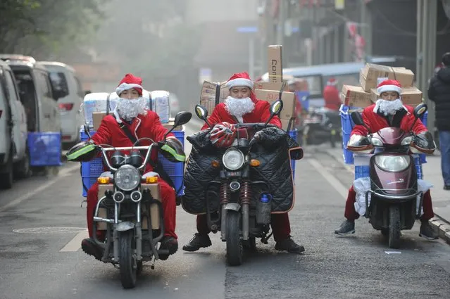 Deliverymen of JD.com dressed as Santa Claus set off to work in Chengdu, Sichuan province, December 22, 2015. (Photo by Reuters/China Daily)