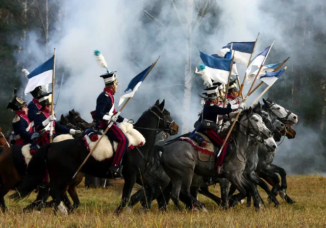 People dressed in the historic uniforms of the French army take part in a re-enactment of the 1812 Battle of Berezina, to mark the 204th anniversary of the battle, near the village of Bryli, Belarus, November 27, 2016. (Photo by Vasily Fedosenko/Reuters)