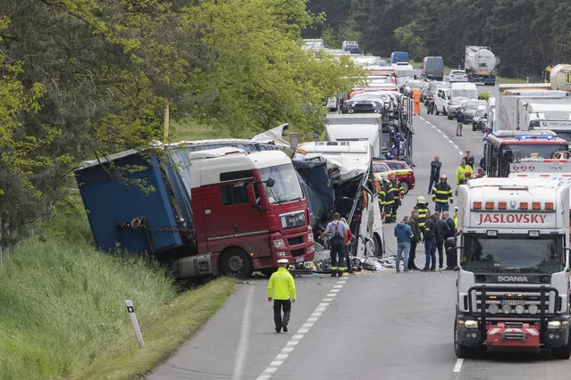 Police and ambulance crews on the scene of a crash on the D2 highway, western Slovakia, Monday, May 15, 2023. Police says a crash between a bus and truck on a major highway in western Slovakia has injured 37 people. They say the accident closed the D2 highway that links the Slovak capital, Bratislava, with the neighboring Czech Republic. (Photo by Michal Svítok/TASR via AP Photo)