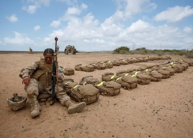 A female recruits from U.S. Marine Corps Recruit Depot San Diego cleans her weapon as she participates in the grueling crucible training for her platoon to become the first ever women Marines trained at Camp Pendleton, California, U.S., April 21, 2021. (Photo by Mike Blake/Reuters)