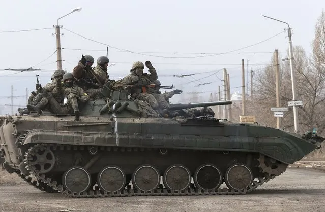 Ukrainian servicemen ride on a military vehicle near Artemivsk February 19, 2015. (Photo by Gleb Garanich/Reuters)