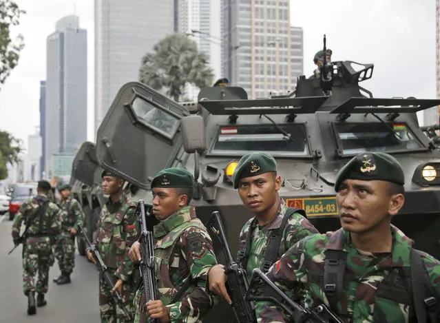 Indonesian soldiers stand guard near the site where an explosion went off in Jakarta, Indonesia Thursday, January 14, 2016. (Photo by Dita Alangkara/AP Photo)