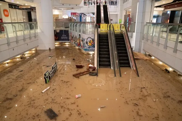Flood water covers the floor of a shopping mall in Hong Kong on September 8, 2023. (Photo by Bertha Wang/AFP Photo)