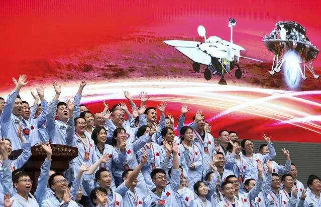 In this photo released by Xinhua News Agency, members at the Beijing Aerospace Control Center celebrate after China's Tianwen-1 probe successfully landed on Mars, at the center in Beijing, Saturday, May 15, 2021. China landed a spacecraft on Mars for the first time on Saturday, a technically challenging feat more difficult than a moon landing, in the latest advance for its ambitious goals in space. (Photo by Jin Liwang/Xinhua via AP Photo)