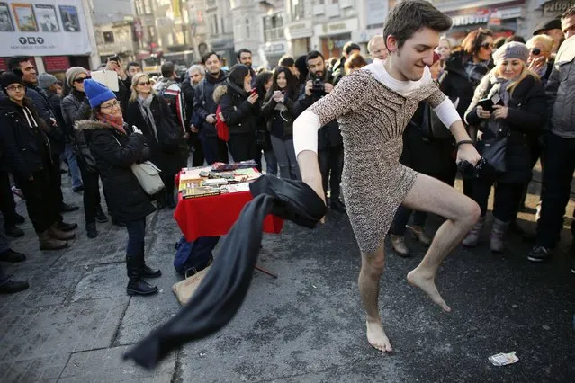 Kaan Vural, a Turkish-South African man, wears a woman's dress to take part in a protest against domestic violence, in central Istanbul February 21, 2015. Turkey's president on February 16, 2015, described violence against women as the “bleeding wound” of the country after a woman was stabbed and beaten to death after trying to fight off a man trying to rape her. Despite a surge in violence against women in Turkey last year, the particularly brutal, and public, attack on Ozgecan Aslan, 20, has become a rallying point, prompting protests and condemnation by politicians. (Photo by Murad Sezer/Reuters)