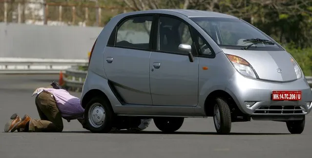 A journalist inspects a 'Nano' car during a test drive session at the company's plant in Pimpri, south-east of Mumbai in this March 25, 2009 file photo. (Photo by Punit Paranjpe/Reuters)