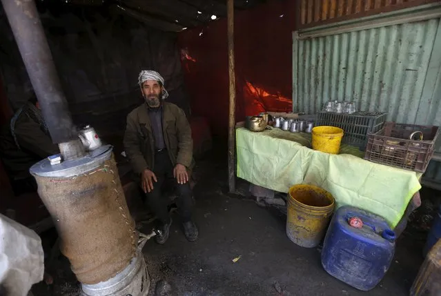 A man sells tea at a roadside as he poses for a photo at his shop in Kabul, Afghanistan November 29, 2015. (Photo by Omar Sobhani/Reuters)