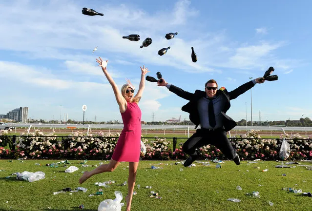 Race goers enjoy the atmosphere at the end of the day at the Melbourne Cup at Flemington Racecourse in Melbourne, Tuesday, November 5, 2013. (Photo by Dan Himbrechts/AAP/Press Association Images)