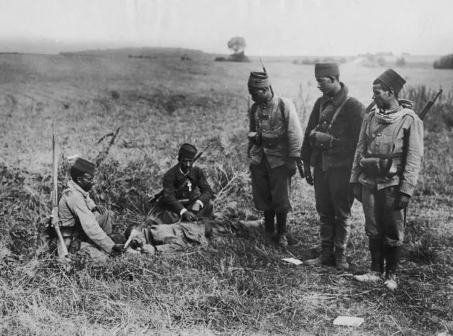 A group of Tirailleurs or “Turcos'”(French colonial infantrymen) offer help to a wounded German soldier after the Battle of the Marne, World War I, circa 1914. (Photo by FPG/Hulton Archive/Getty Images)