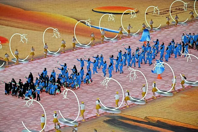 Iran's delegation takes part in the athletes parade during the opening ceremony of the 2022 Asian Para Games at the Hangzhou Olympic Sports Centre Stadium in Hangzhou in China's eastern Zhejiang province on October 22, 2023. (Photo by Hector Retamal/AFP Photo)