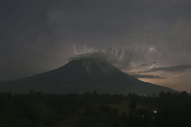 Lightning strikes as Mount Sinabung volcano spews ash and hot lava, at Simpang Empat village in Karo district, September 18, 2013. (Photo by Y. T. Haryono/Reuters)