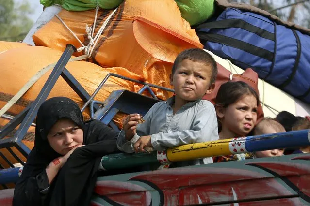 Afghan children onboard a truck wait for their registration at a UNHCR voluntary repatriation center for retuning to their homeland, in Peshawar, Pakistan, Monday, October 30, 2023. U.N. agencies have reported a sharp increase in Afghans returning home since Pakistan launched a crackdown on people living in the country illegally. Pakistan earlier this month said it will arrest and deport undocumented or unregistered foreigners after Oct. 31. (Photo by Muhammad Sajjad/AP Photo)