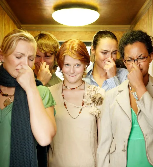 People in lift holding noses, one woman smiling. (Photo by Stuart McClymont/Getty Images)