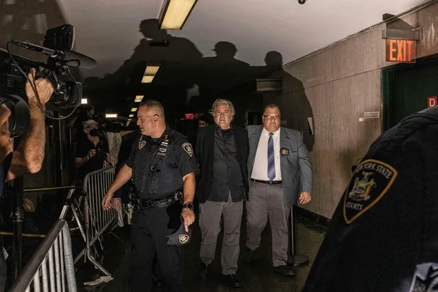 Donald Trump's former advisor Steve Bannon (C) is led away from a New York court in handcuffs on September 8, 2022. Bannon, 68, was indicted on state charges of money laundering, conspiracy and fraud related to an alleged online scheme to raise money for the construction of the US-Mexico border wall. (Photo by Alex Kent/AFP Photo)