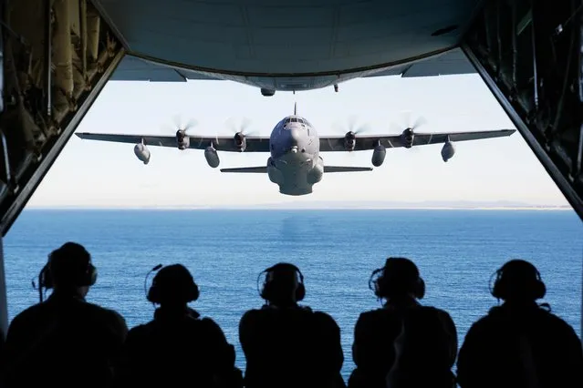 US and Royal Australian Air Force troops watch a special operations MC-130J Commando II being put through its paces in exercises off New South Wales in July 2021. (Photo by 1st Lt Joshua Thompson/US Air Force via Triangle News)
