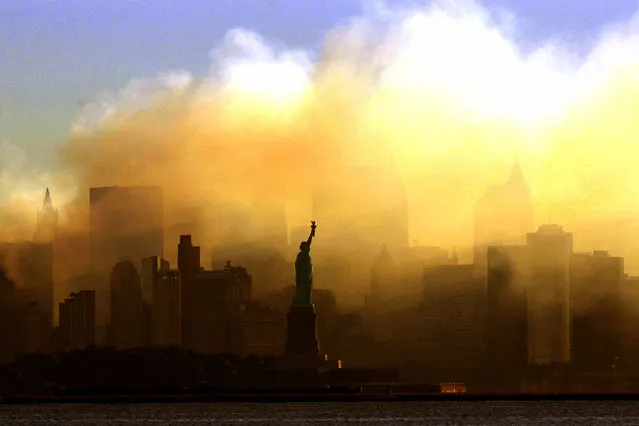 In this Saturday, September 15, 2001 file photo, the Statue of Liberty stands in front of a smoldering lower Manhattan at dawn, seen from Jersey City, N.J. The Sept. 11, 2001 terrorist attacks on the United States nearly 20 years ago precipitated profound changes in America and the world. (Photo by Dan Loh/AP Photo/File)