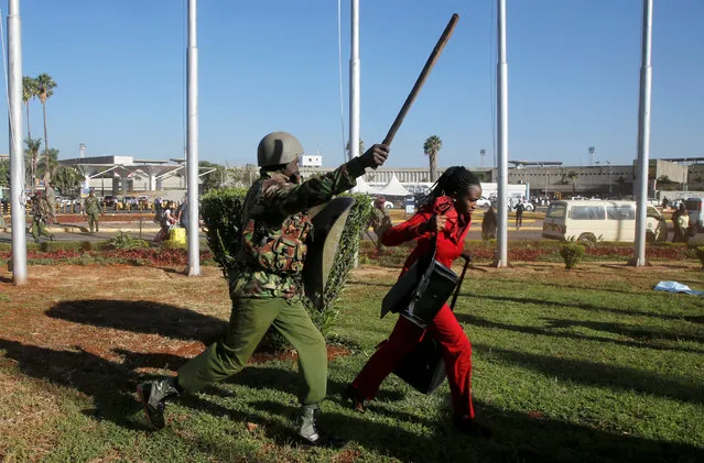 A Kenya Airways worker is dispersed by riot police at the Jomo Kenyatta International Airport during a labour dispute that grounded flights near Nairobi, Kenya on March 6, 2019. Hundreds of travellers were stranded at Nairobi's international airport as riot police were deployed and teargas fired to disperse striking workers. With flights grounded since midnight, passengers were advised not to come to the Jomo Kenyatta International Airport – East Africa's busiest according to the Kenya Airports Authority (KAA) – until further notice. (Photo by Thomas Mukoya/Reuters)