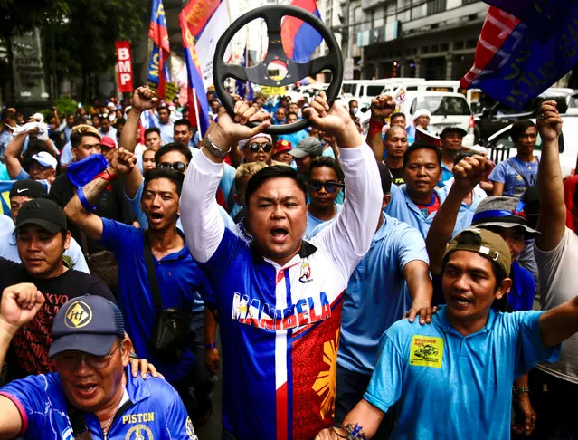 Jeepney drivers shout slogans as they stage a protest rally during a transport strike in Manila, Philippines, 29 December 2023. Jeepney drivers protested the government's plan to modernize public transport and potentially phase out their vehicles, which have been a unique symbol of mass transport in the country through many generations. President Ferdinand Marcos Jr. announced that the government will not extend its year-end deadline for the dilapidated jeepneys' phase out. (Photo by Francis R. Malasig/EPA/EFE)