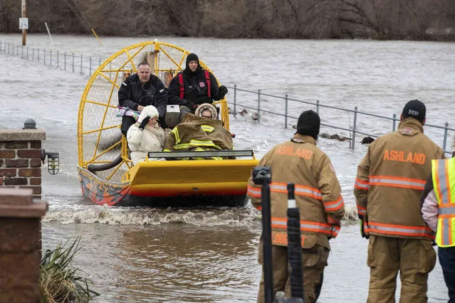 Mary Roncka and her husband Gene Roncka, right, accompanied by neighbor Kevin Mandina are evacuated as floodwaters rise Thursday, March 13, 2019, in Ashland, Neb. Evacuations forced by flooding have occurred in several eastern Nebraska communities, as western Nebraska residents struggled with blizzardlike conditions. (Photo by Brendan Sullivan/Omaha World-Herald via AP Photo)