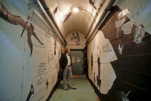 Visitor looks at an art installation on the wall inside a bunker in Konjic, Bosnia and Herzegovina, April 24, 2015. A group of Bosnian artists plan to turn the former atomic-bomb bunker, once the best kept secret of socialist Yugoslavia, into a vast museum dedicated to the Cold War. (Photo by Dado Ruvic/Reuters)