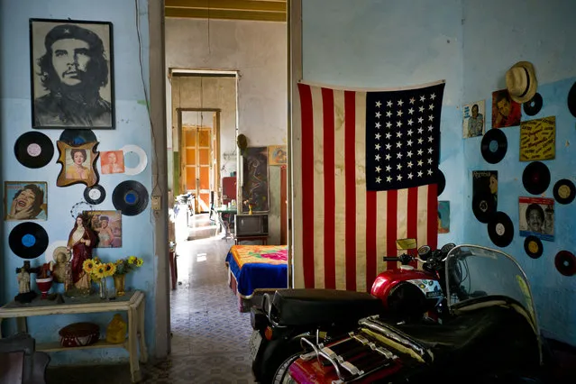 An image of revolutionary hero Ernesto “Che” Guevara hangs on a wall across the doorway from a Stars and Stripes tacked to a wall, in Havana, Cuba, Tuesday, March 15, 2016. (Photo by Ramon Espinosa/AP Photo)