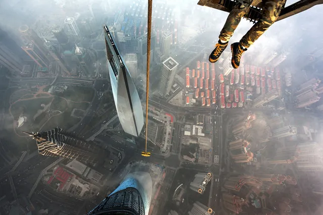 Urban ninjas, Vadim Makhorov and Vitaly Raskalov, climbed continuously for two hours before conquering the partly constructed, Shanghai tower. (Photo by Vitaly Raskalov/Caters News Agency)