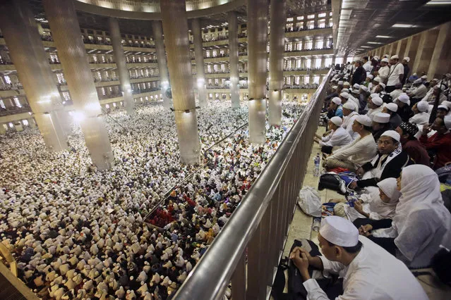 Muslim men attend a prayer at Istiqlal Mosque in Jakarta, Indonesia Saturday, February 11, 2017. Tens of thousands gathered at the national mosque for the mass prayers on Saturday urging Indonesians to vote for Muslims in city and district elections being held across the country next week. (Photo by Achmad Ibrahim/AP Photo)