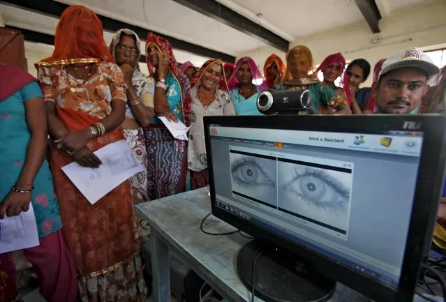 Village women stand in a queue to get themselves enrolled for the Unique Identification (UID) database system in Merta district of the desert Indian state of Rajasthan, in this February 22, 2013 file photo. (Photo by Mansi Thapliyal/Reuters)