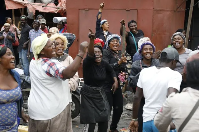 People celebrate the arrival of the Protected Areas Security Brigade (BSAP) as they protest for the second consecutive day against Prime Minister Ariel Henry, demanding his ouster, in Port-au-Prince, Haiti, Tuesday, February 6, 2024. (Photo by Odelyn Joseph/AP Photo)