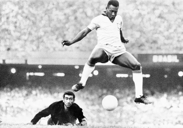 Brazil's Pele scores past Venezuela's goal keeper Fabrizio Fasano in Rio de Janeiro, Brazil, August 24, 1969. Pelé, the Brazilian king of soccer who won a record three World Cups and became one of the most commanding sports figures of the last century, died in Sao Paulo on Thursday, Dec. 29, 2022. He was 82. (Photo by AP Photo, File)