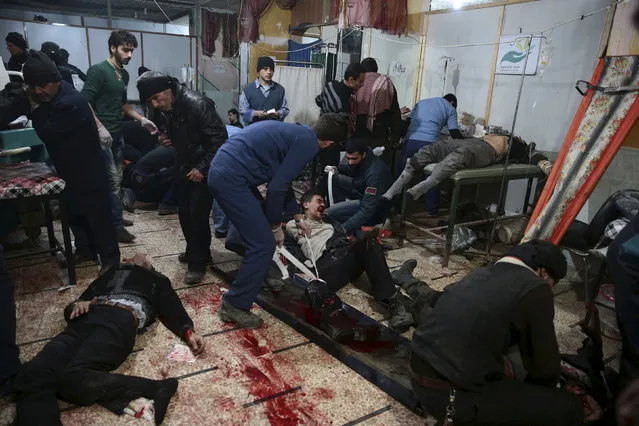 Medics treat injured people inside a field hospital after what activists said were air and missile strikes in the Douma neighborhood of Damascus, Syria December 13, 2015. (Photo by Bassam Khabieh/Reuters)