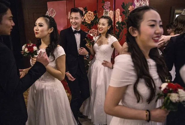 Debutantes from a local academy gather before taking part in the Vienna Ball at the Kempinski Hotel, March 19, 2016, in Beijing. (Photo by Kevin Frayer/Getty Images)
