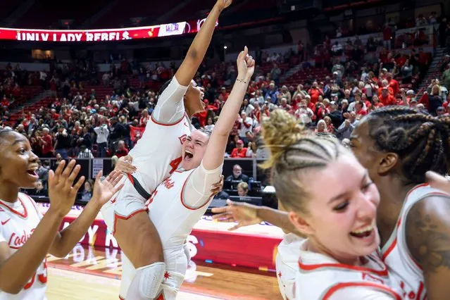 UNLV forward Alyssa Brown (44) and center Erica Collins (31) celebrate with teammates after a win over San Diego State in an NCAA college basketball game for the championship of the Mountain West women's tournament Wednesday, March 13, 2024, in Las Vegas. (Photo by Ian Maule/AP Photo)