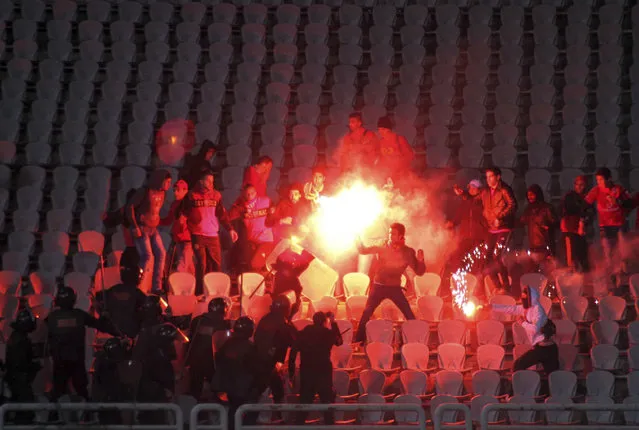 In this February 1, 2012 file photo, Egyptian fans clash with riot police following an Al-Ahly club soccer match against Al-Masry club at the soccer stadium in Port Said, Egypt. On Monday, Feb. 20, 2017, Egypt's highest appeals court upheld the death sentences against 10 people convicted over a soccer riot in 2012 that killed over 70 fans, becoming one of the world's deadliest soccer disasters. The verdict by the Court of Cassation is final. The defendants were charged with murder along with several other charges. Also, the court also upheld the convictions of 22 suspects who received up to 10 years in prison over the rioting. (Photo by AP Photo)