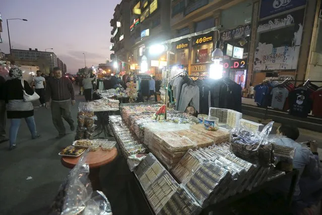 Syrian street vendor sells sweets in an area called 6 October City in Giza, Egypt, March 19, 2016. (Photo by Mohamed Abd El Ghany/Reuters)