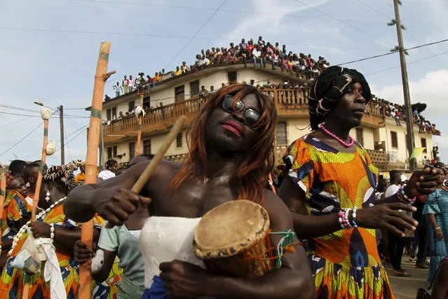 Men dressed as women take part in a parade during the Popo (Mask) Carnival of Bonoua, in the east of Abidjan, April 9, 2016. (Photo by Luc Gnago/Reuters)