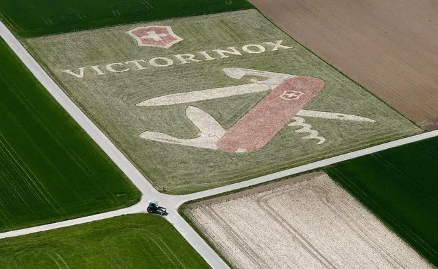 An aerial view shows a giant advertisement of Swiss knife manufacturer Victorinox on a field on the approach to Zurich airport near Niederglatt, Switzerland, April 22, 2016. (Photo by Arnd Wiegmann/Reuters)