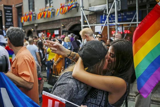 Women kiss each other as people celebrate outside the Stonewall Inn in the Greenwich Village neighborhood of New York June 26, 2015. The Supreme Court ruled on Friday that the U.S. Constitution provides same-s*x couples the right to marry, handing a historic triumph to the American gay rights movement. (Photo by Eduardo Munoz/Reuters)