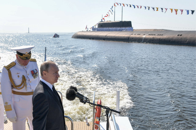 Russia's President Vladimir Putin (R) and Admiral Nikolai Yevmenov, Commander-in-Chief of the Russian Navy, inspecting vessels taking part in a military parade in the Kronstadt roadstead on Russian Navy Day, on the Raptor boat in Kronshtadt, Russia on July 28, 2019. (Photo by Alexei Nikolsky/Russian Presidential Press and Information Office/TASS)