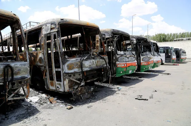 Buses, which witnesses said were burnt by workers from construction company Saudi Binladin Group in a protest over delayed wages, are seen in Mecca, Saudi Arabia May 1, 2016. (Photo by Bandar Al Dandani/Reuters)