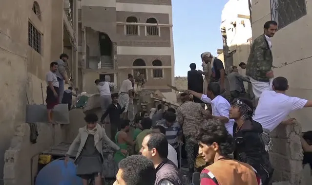 In this frame grab from from video, people search in the rubble following Saudi-led coalition airstrikes that killed at least six, including children, officials said, in the residential center of the capital, Sanaa, Yemen. The Sanaa airstrikes came after Yemen's Iran-backed Houthi rebels, who control the capital, launched a drone attack earlier in the week on a critical oil pipeline in Saudi Arabia, Tehran's biggest rival in the region. (Photo by AP Photo)