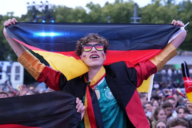 A fan cheers as he watches a Group A match between Germany and Scotland at the Euro 2024 soccer tournament in Berlin, Germany, Friday, June 14, 2024. (Photo by Ebrahim Noroozi/AP Photo)