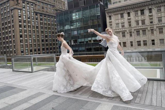 In this Friday, April 21, 2017 photo, the Monique Lhuillier bridal collection is modeled during bridal fashion week in New York. (Photo by Mary Altaffer/AP Photo)